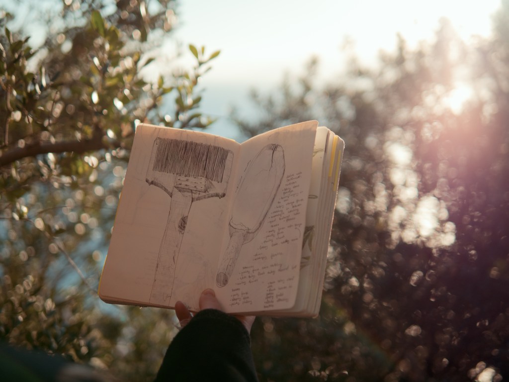 notebook with fine line illustration with a pen