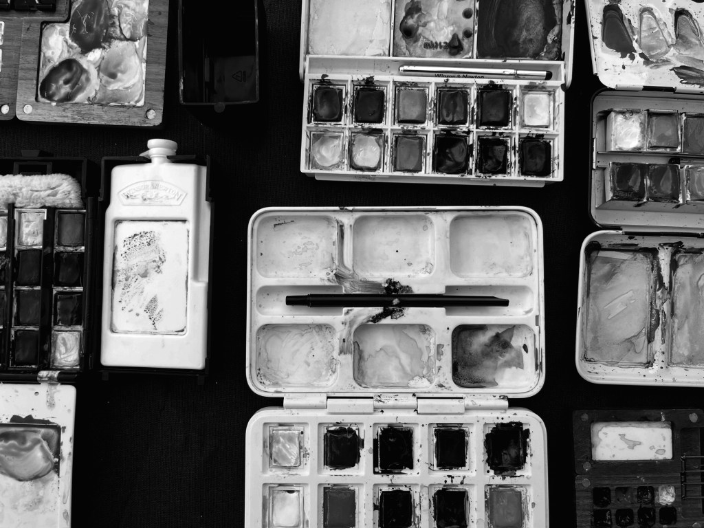 art supplies arranged neatly on a table - watercolors