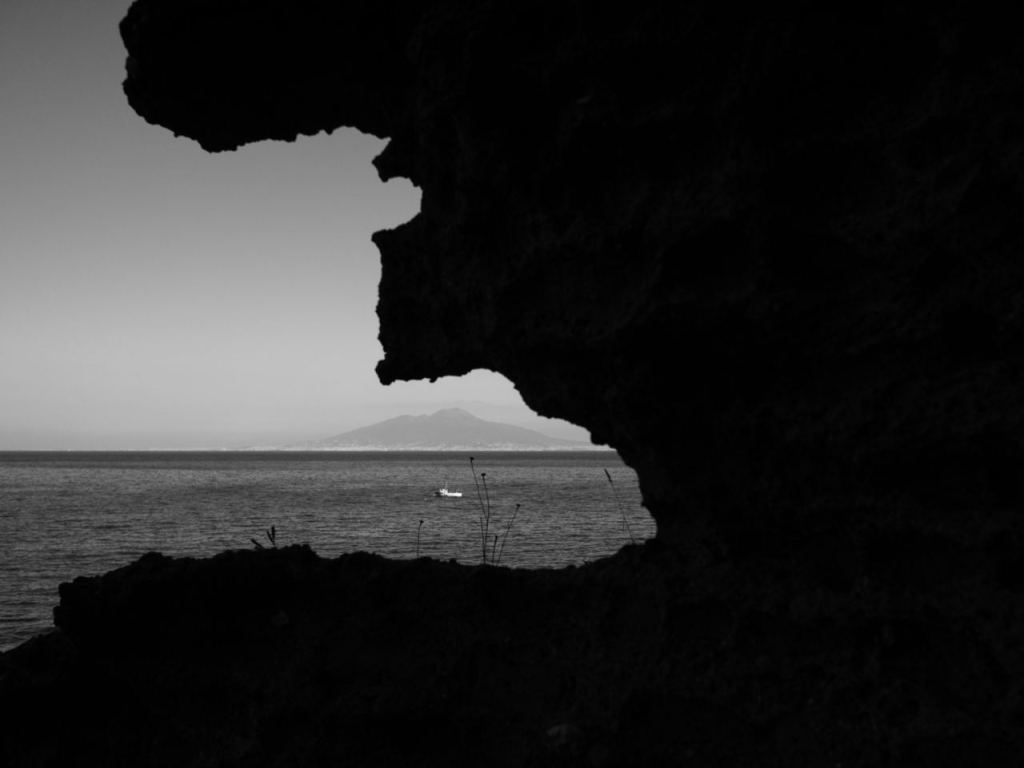 contrasting photo with sea and Naples in the background